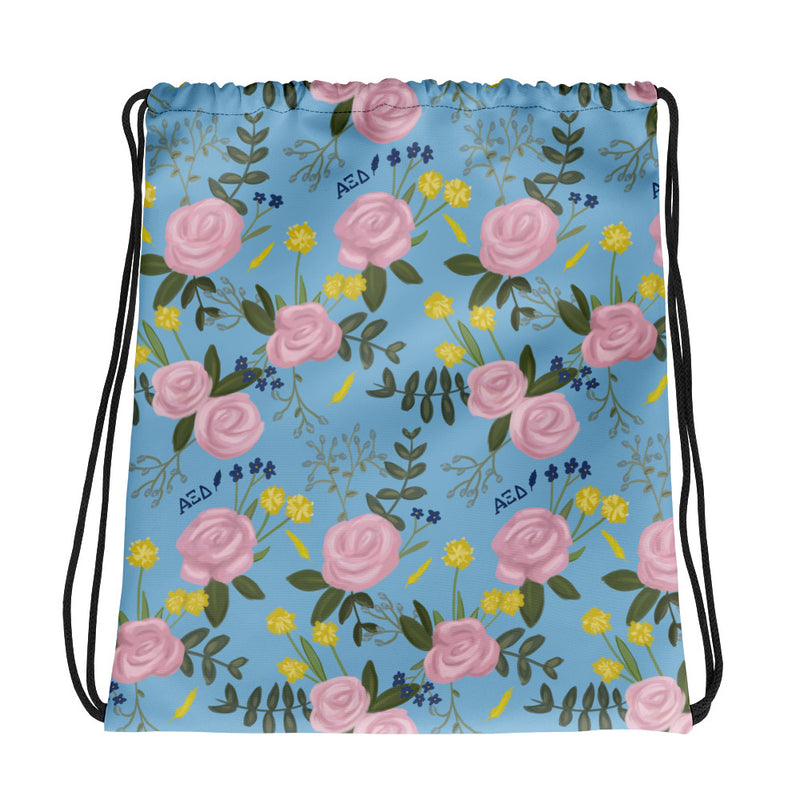 Alpha Xi Delta Floral Drawstring Bag shown flat in light blue