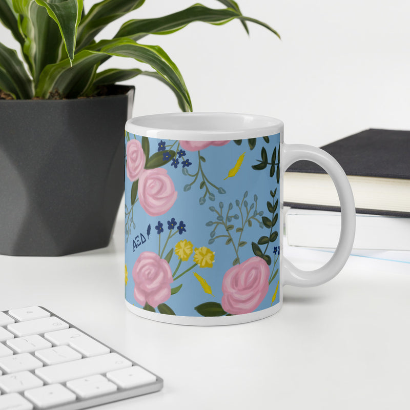 Alpha Xi Delta Floral Pattern Light Blue Glossy Mug  in 11 oz size shown in office