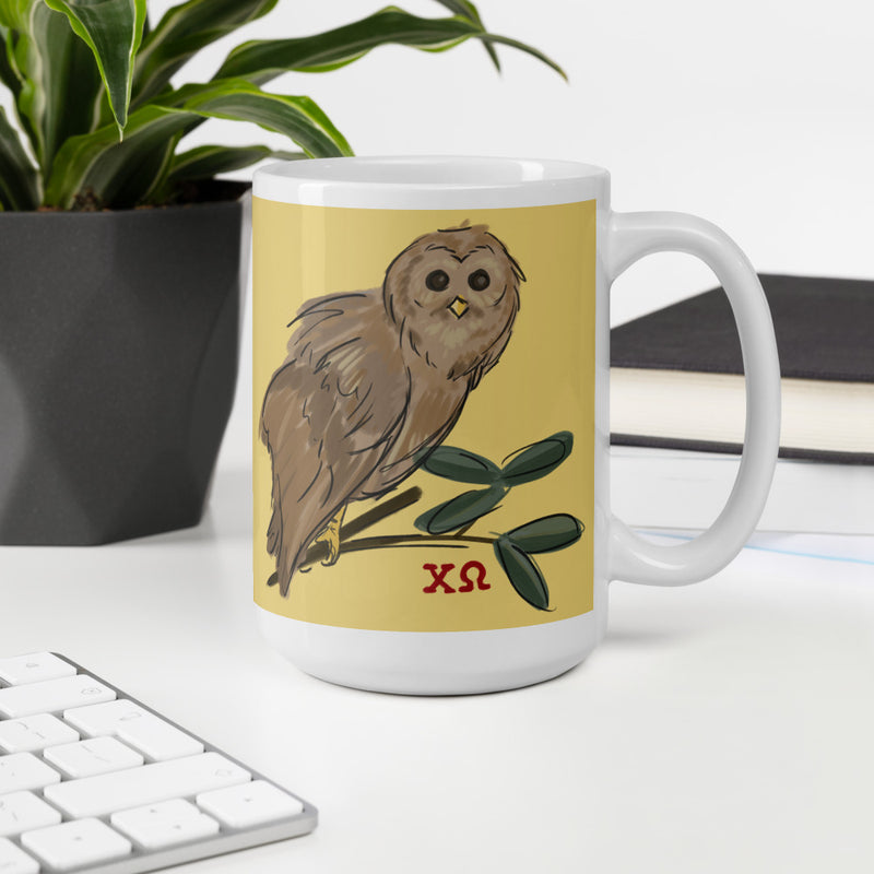 Chi Omega Owl Mug in 15 oz size in straw gold with owl design in office setting