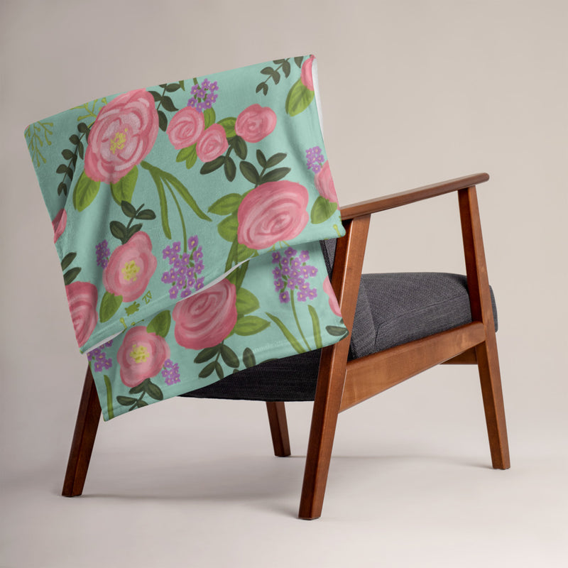 Delta Zeta Pink Killarney Rose Throw Blanket, Green shown on a chair