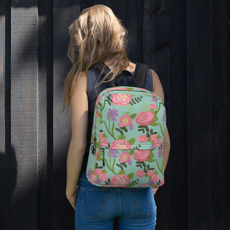 Delta Zeta pink rose floral print backpack with light green background shown on model