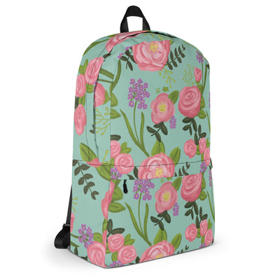 Side of Delta Zeta pink rose floral print backpack with light green background.