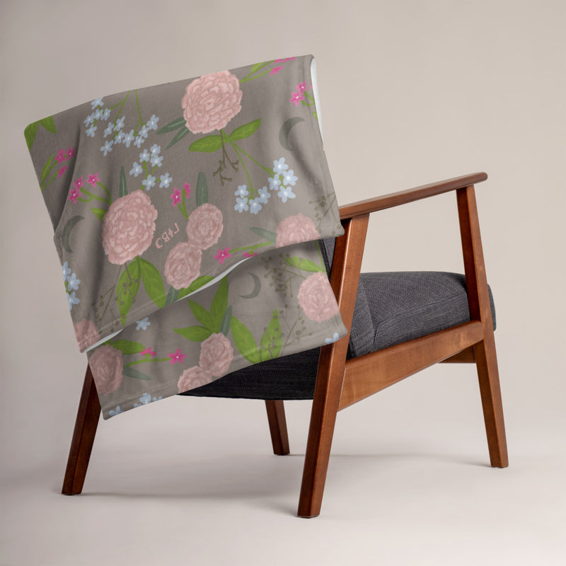 Gamma Phi Beta Pink Carnation Throw Blanket, Mocha shown on a chair