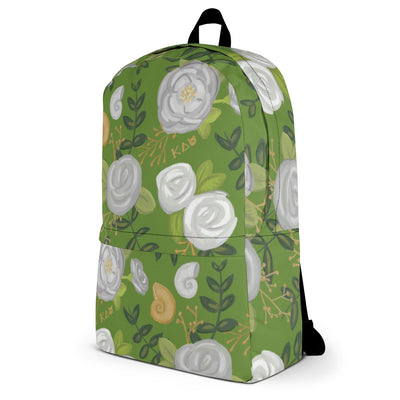 Kappa Delta white rose print backpack with a green background showing right side of bag