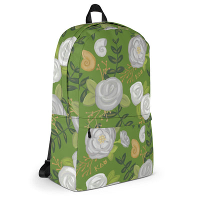 Kappa Delta white rose print backpack with a green background showing side of bag