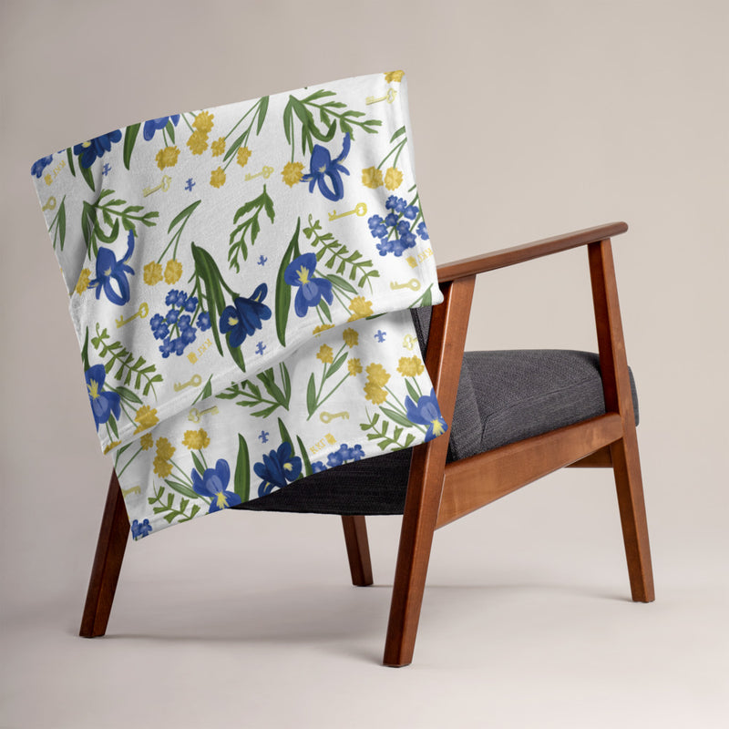 Kappa Kappa Gamma Fleur de Lis and Key Throw Blanket in white shown on chair