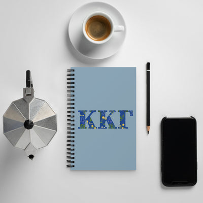 Kappa Kappa Gamma Greek Letters Spiral Notebook shown with coffee