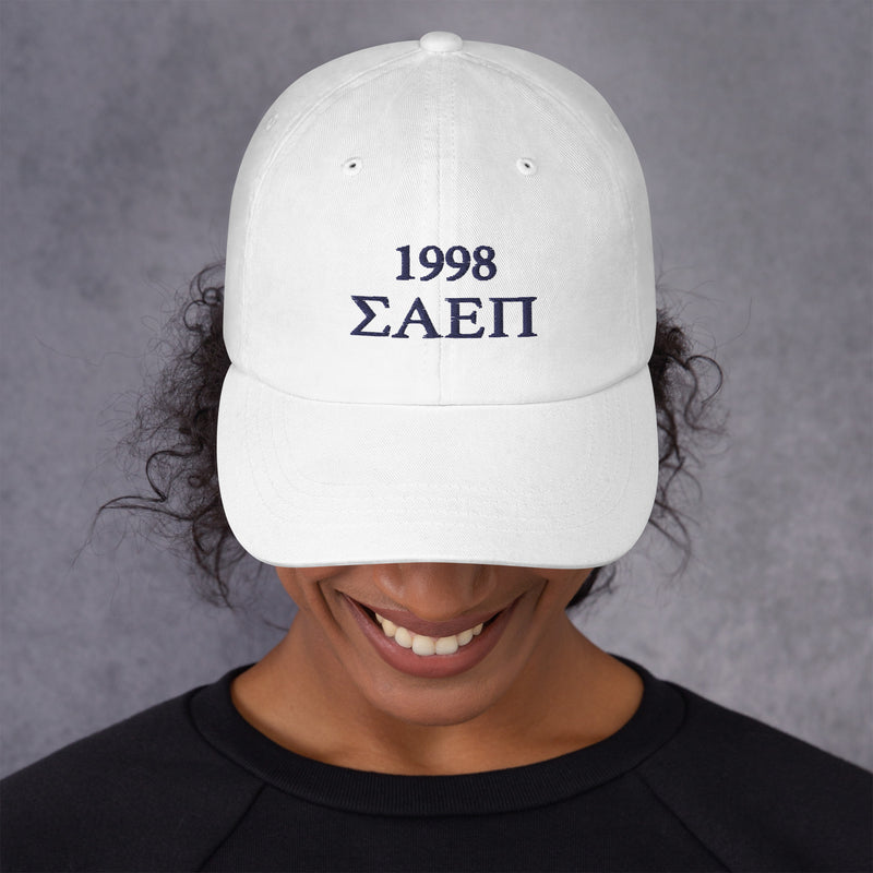 Sigma Alpha Epsilon Pi embroidered baseball hat in white with Navy Blue letters shown on model&