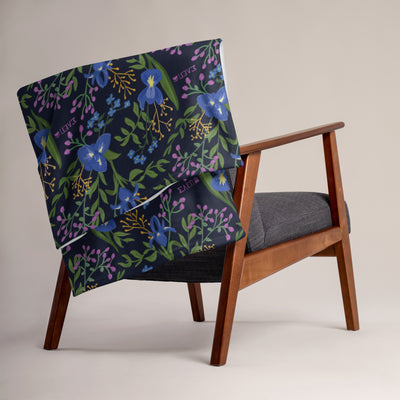 Sigma Alpha Epsilon Pi floral throw blanket shown on a chair