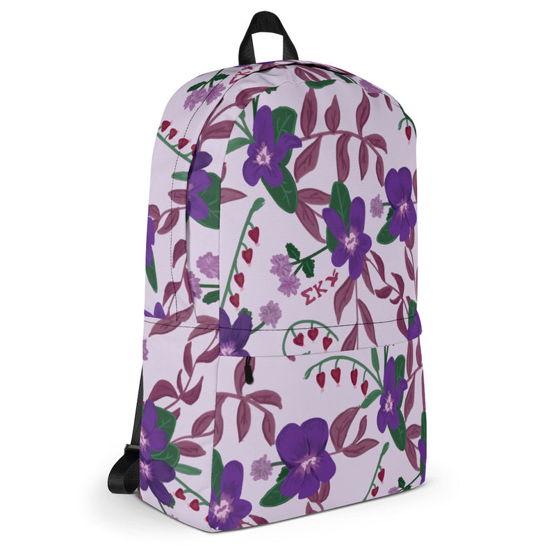 Sigma Kappa violet print backpack with a light purple background showing side view.