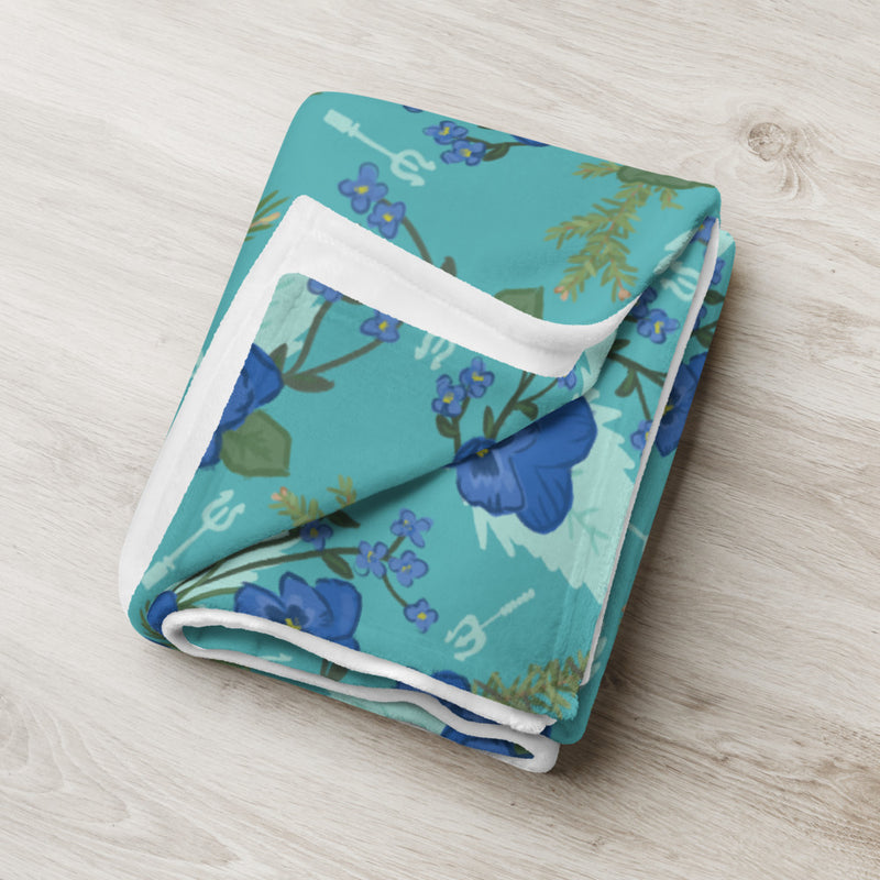 Tri Delta Pansy Floral Print Teal Throw Blanket shown folded