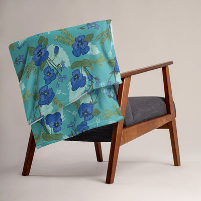 Tri Delta Pansy Floral Print Teal Throw Blanket shown on a chair