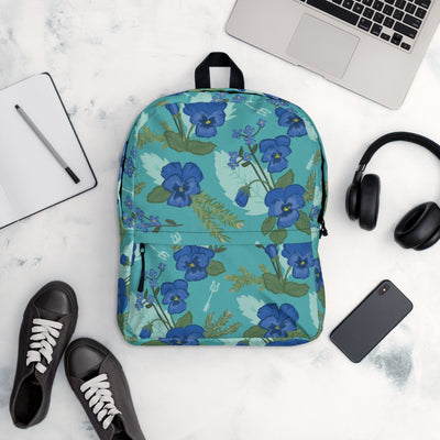 Tri Delta Pansy Floral print backpack with a teal background.