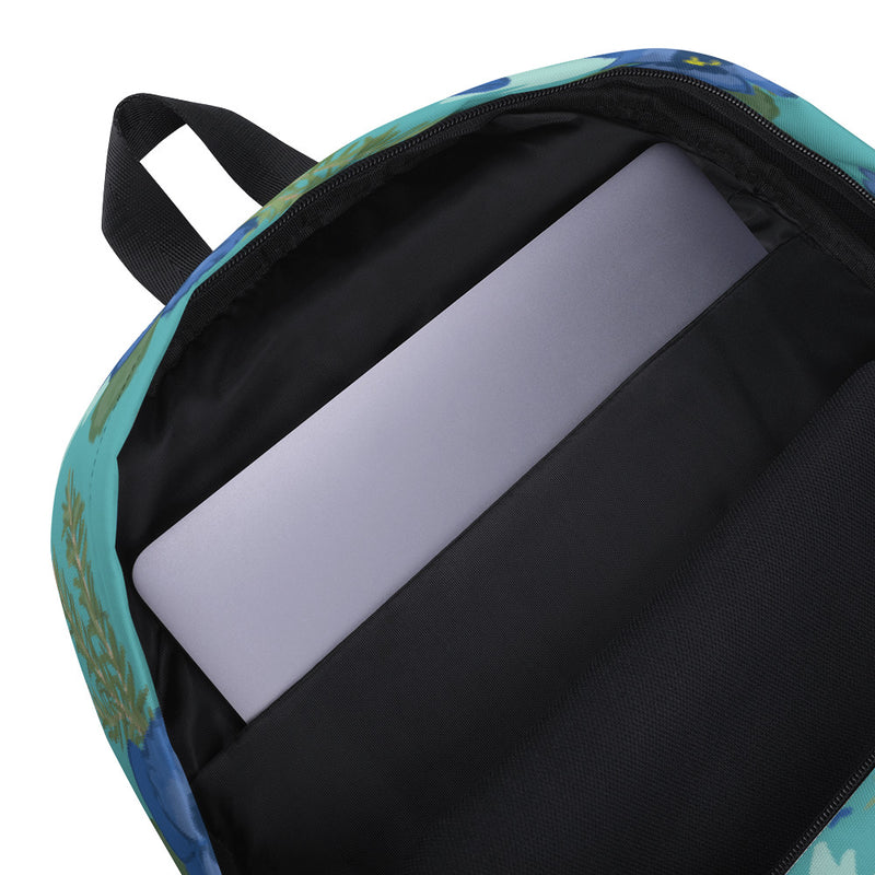 Inside view of the Tri Delta Pansy Floral print backpack with a teal background.