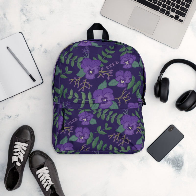 Tri Sigma violet floral print backpack in purple shown in lifestyle setting