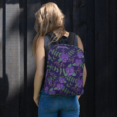 Tri Sigma violet floral print backpack with a purple background shown on model's back