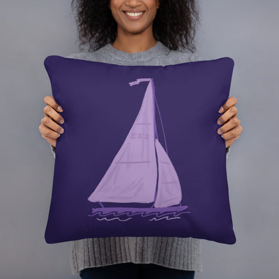 Tri Sigma Sailboat Mascot Pillow in model's hands showing sailboat design on front