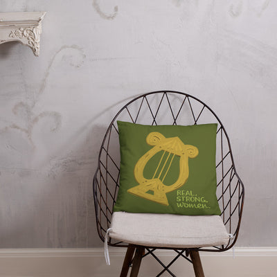 Alpha Chi Omega Real. Strong. Women green throw pillow shown on chair
