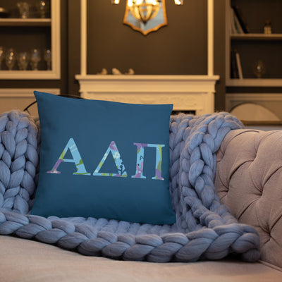 Alpha Delta Pi Greek Letters Pillow shown on couch