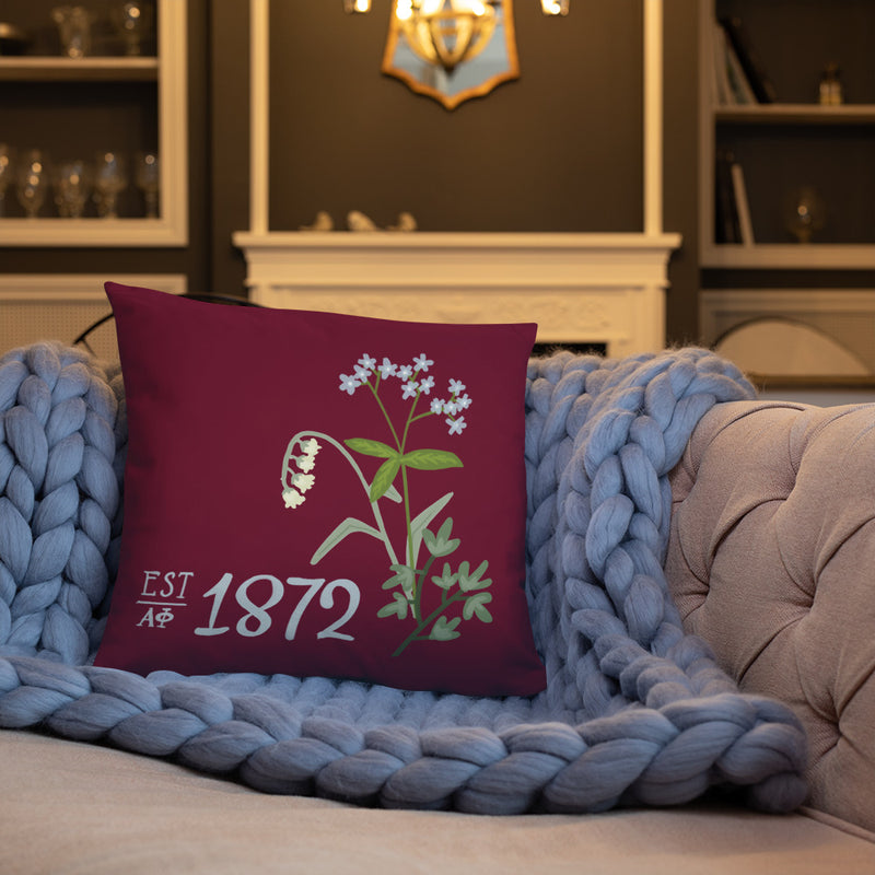 Alpha Phi 1872 two-sided, reversible pillow shown on couch