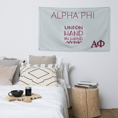 Alpha Phi Union Hand in Hand Flag, Silver and Bordeaux shown in bedroom
