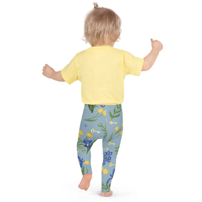 Kappa Kappa Gamma Floral Print Kid's Leggings, Sea Blue showing back of design on toddler
