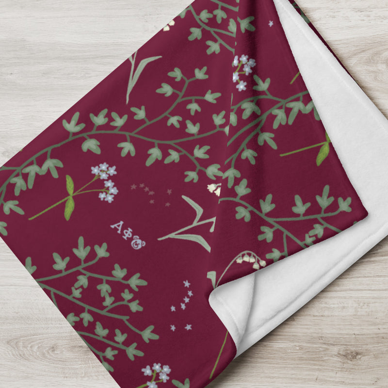 Alpha Phi Ivy and Lily of the Valley Floral Print Throw Blanket in Bordeaux shown close up