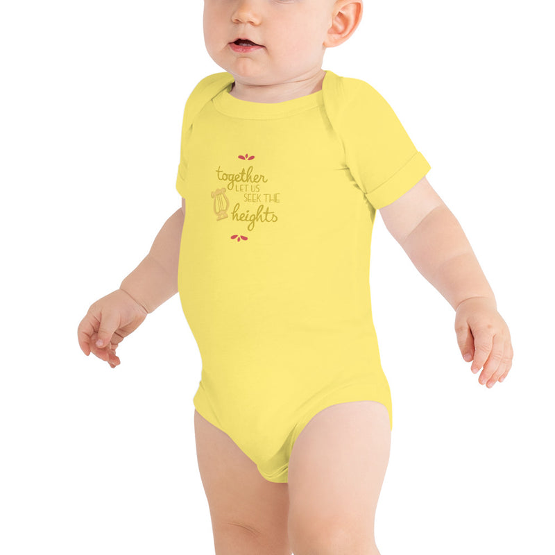 Alpha Chi Omega Baby Onesie shown on child model in yellow 