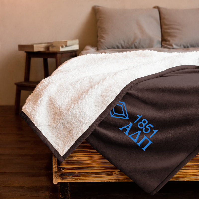 Alpha Delta Pi Plush Embroidered Sherpa Blanket in brown on bed