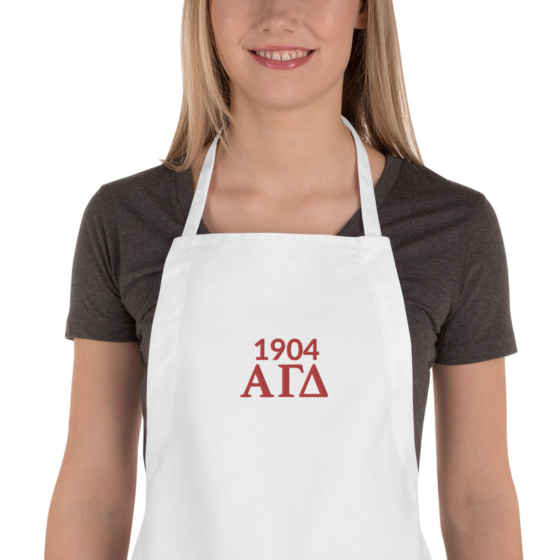 Alpha Gamma Delta Sorority Apron on model in white with 1904 and letters 