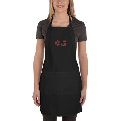 Alpha Omicron Pi Sorority Apron shown in black with red AOII founding date, letters and infinity rose on model in full view