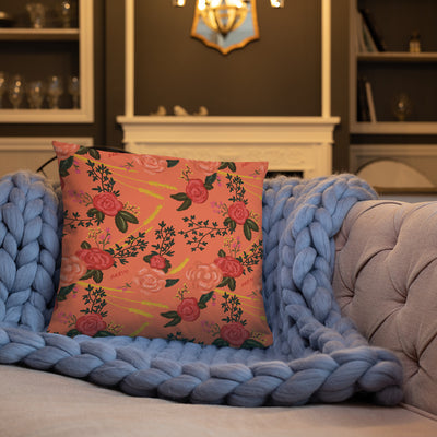 Alpha Omicron Pi Inspire Ambition Coral Pillow shown on a couch and showing floral print