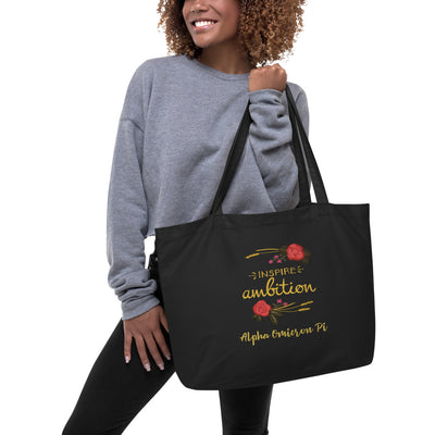 Alpha Omicron Pi Sorority Tote Bag in black shown on model's arm with motto design