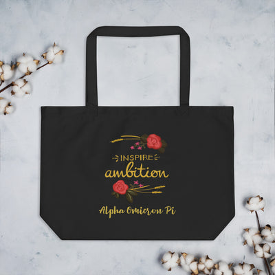 Alpha Omicron Pi Sorority Tote Bag in black shown with cotton blossoms with motto design