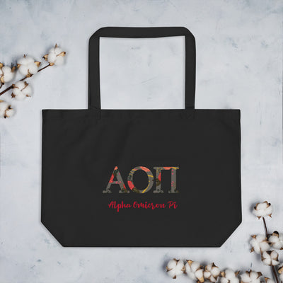 Alpha Omicron Pi Sorority Tote Bag with filled letters on larger Eco Tote Bag shown in black with cotton blossoms