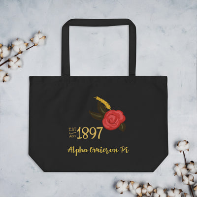 Alpha Omicron Pi Sorority Tote Bag in black shown flat with cotton flowers with 1897 design