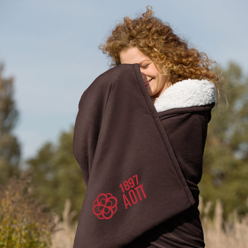 Alpha Omicron Pi Plus Embroidered Sherpa Blanket in brown on model