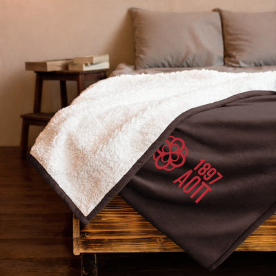 Alpha Omicron Pi Plus Embroidered Sherpa Blanket in brown on bed
