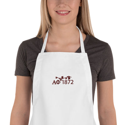 Alpha Phi Embroidered Apron with letters in burgundy on white apron on model