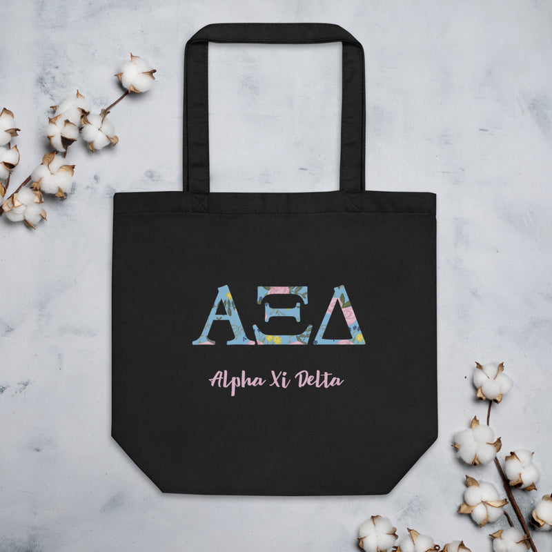 Alpha Xi Delta Sorority Tote Bag in black shown with cotton flowers