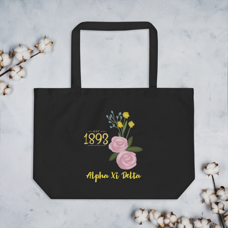 Alpha Xi Delta 1893 Sorority Tote Bag in black shown flat with cotton blossoms