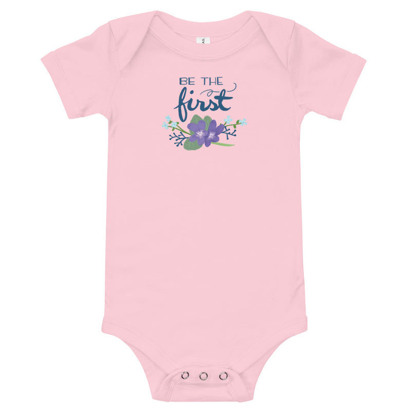 Alpha Delta Pi Be The First Baby Onesie shown flat in pink