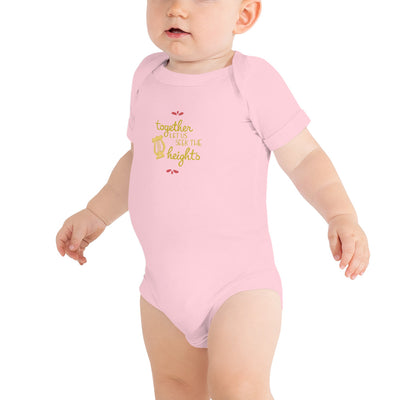 Alpha Chi Omega Together Let Us Seek The Heights Baby Onesie in pink shown on infant