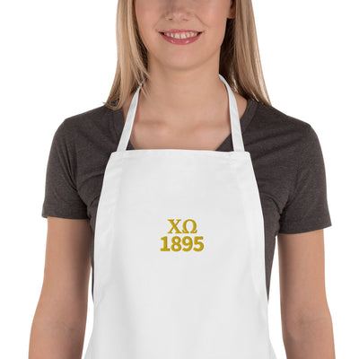 Chi Omega Embroidered Apron in white with gold embroidery shown on model