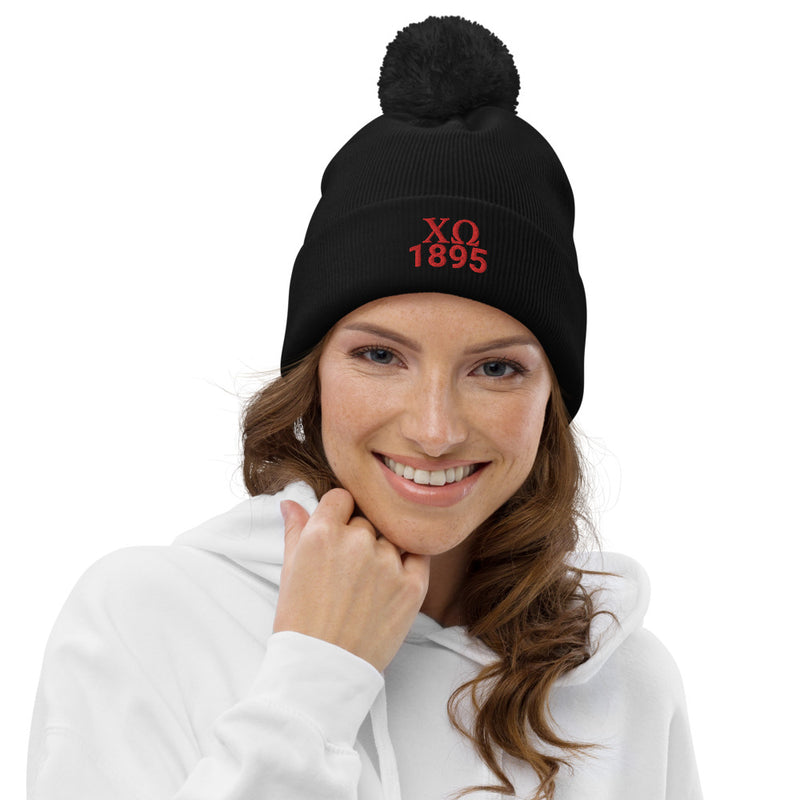 Chi Omega Sorority Pom Pom Beanie in black with red embroidery on model