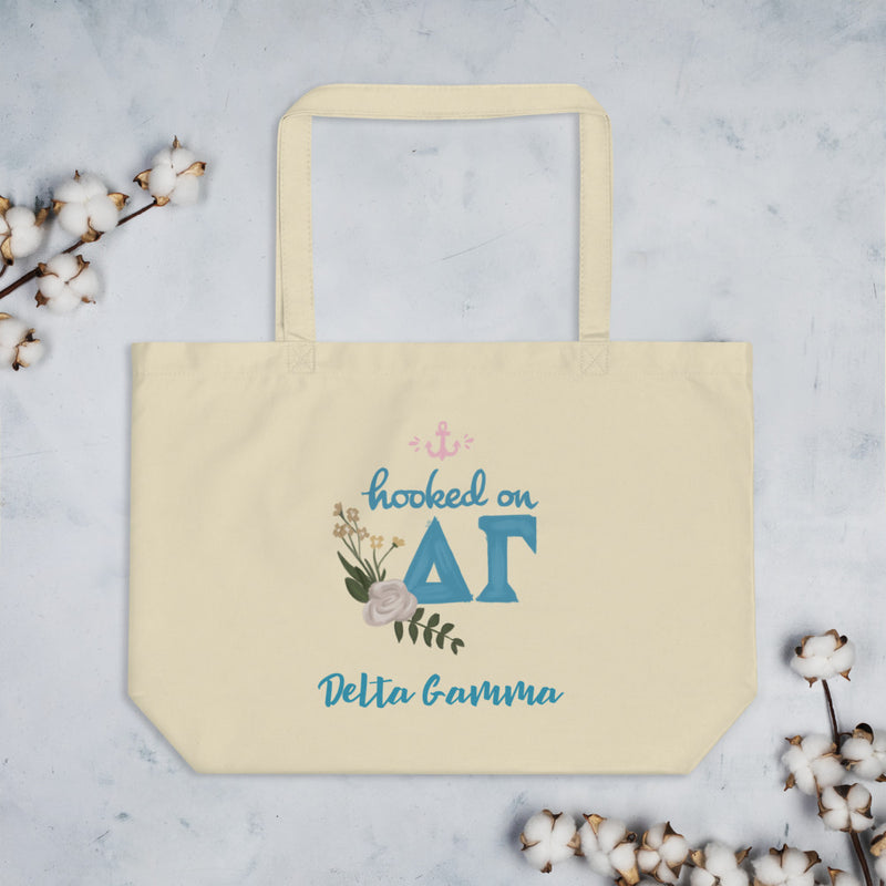 Delta Gamma Hooked on DG Sorority Tote Bag in natural oyster color shown with cotton blossoms