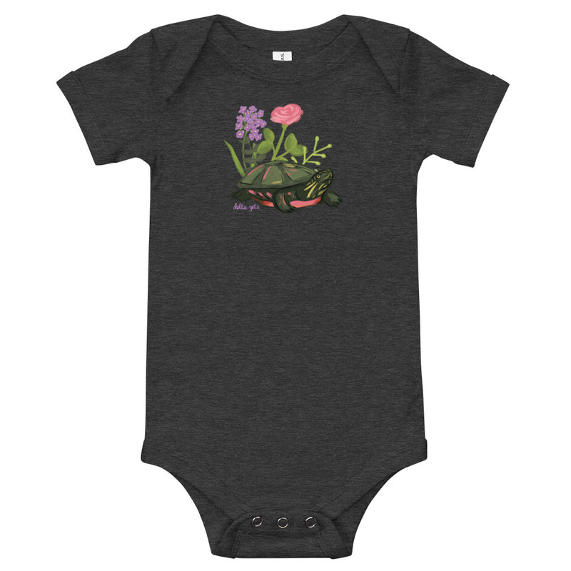 Delta Zeta Turtle Baby Onesie in dark gray shown flat with turtle mascot design