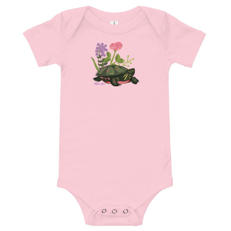 Delta Zeta Turtle Baby Onesie in pink shown flat with turtle mascot design