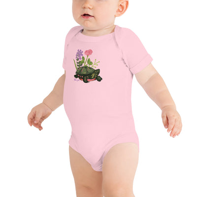 Delta Zeta Turtle Baby Onesie in pink shown on model with turtle mascot design