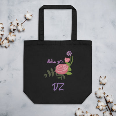 Delta Zeta Sorority Tote Bag in black shown flat with cotton blossoms